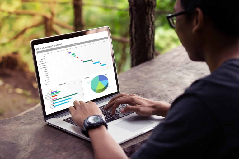 Man working with excel project dashboard on laptop outdoor