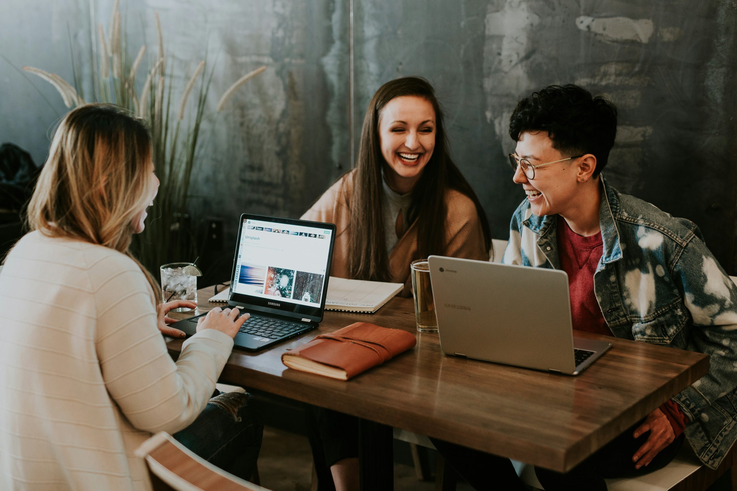 Group communicating to develop a social media plan for their business scaled